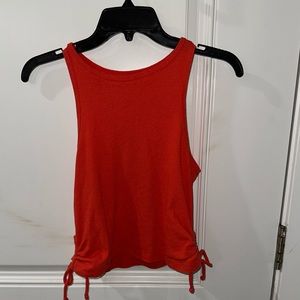 I al selling a size Large red tank top with strings at the bottom